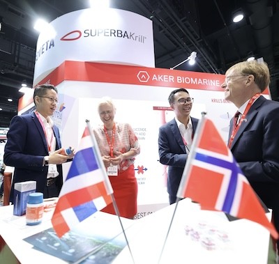 Attendee chatting friendly with a booth hostess at Vitafood Asia